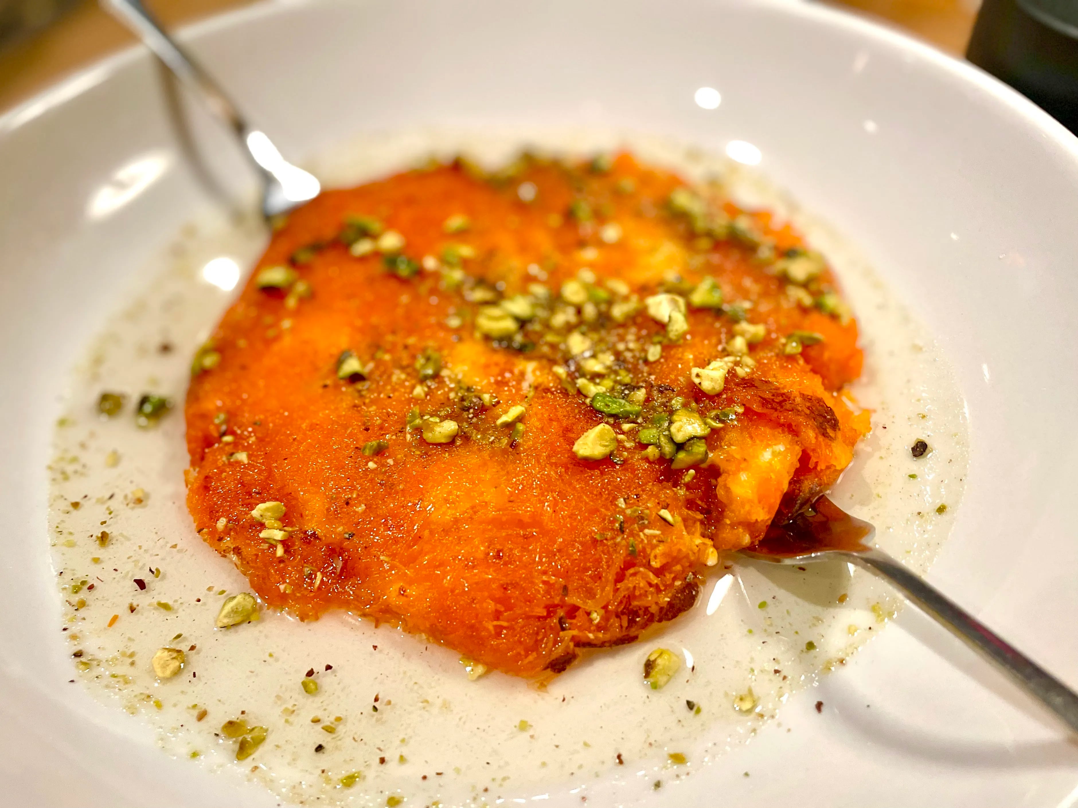 The knafeh Nablusi for two, sandwich oozy cheese between crispy kataifi doused in rosewater syrup, is one of the dessert highlights at Renata's in University City.