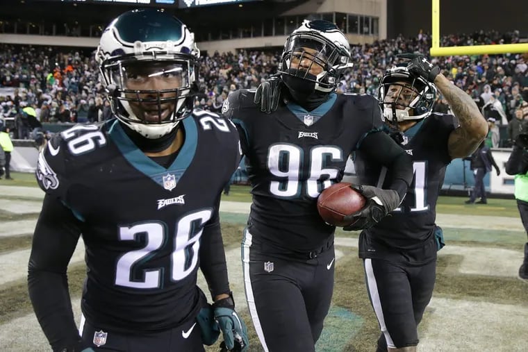 Eagles Derek Barnett, center, celebrates after scoring on a fumble in the 4th quarter. With Barnett is Jaylen Watkins, left, and Ronald Darby, right. Philadelphia Eagles win 19-10 over the Oakland Raiders in Philadelphia, PA on December 25, 2017.