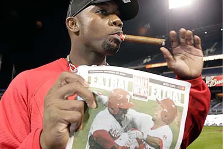 Phillies' Ryan Howard celebrates his return to the World Series with a cigar and a copy of the Daily News. (Yong Kim / Staff Photographer)