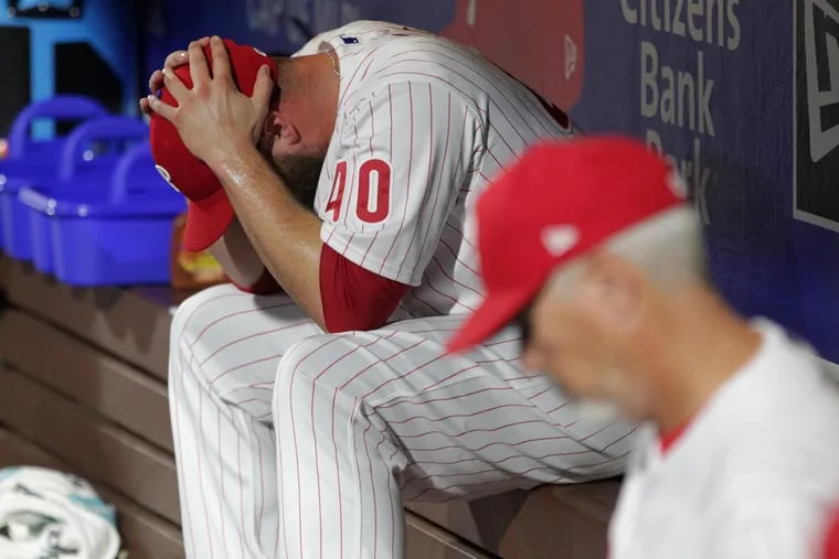 Phillies reliever Tommy Hunter slumps over in the dugout after giving up four runs against the Cardinals in the seventh inning of the Phillies loss on Tuesday.