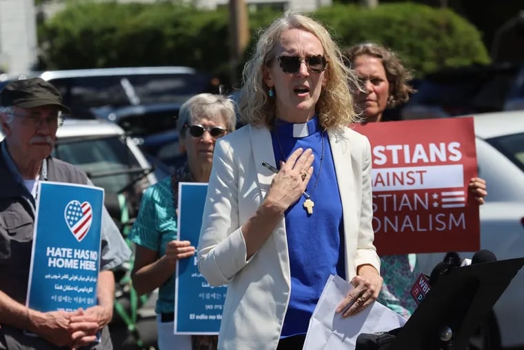 The Rev. Jennifer Butler speaks outside the ReAwaken America Tour stop in Batavia, N.Y., in August. To Butler, the event underscored how little Christian nationalism has to do with Christianity, she writes.