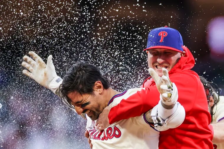 Phillies outfielder Nick Castellanos is doused in water after his walk-off single to win it for the Phillies in the ninth inning against the Pittsburgh Pirates on April 13.