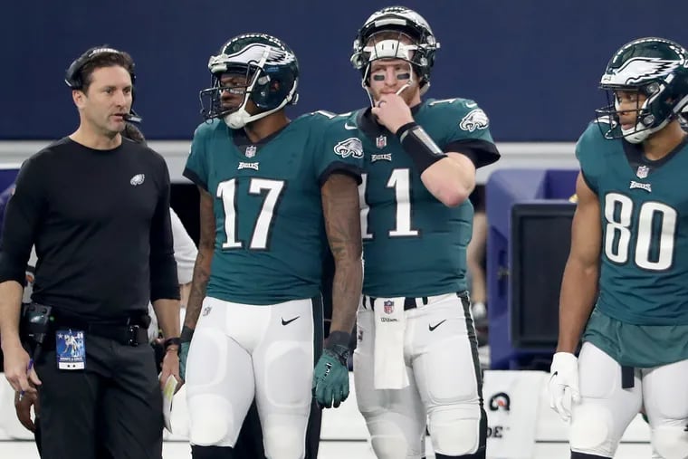 Left to right: EaglesÕ offensive coordinator Mike Groh, Eagles wide receiver Alshon Jeffery, Eagles quarterback Carson Wentz, and Eagles wide receiver Jordan Matthews wait on the sideline during the 1st quarter against the Cowboys. Philadelphia Eagles play the Dallas Cowboys in Arlington, TX on December 9, 2018.  DAVID MAIALETTI / Staff Photographer
