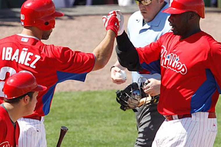 Raul Ibanez congratulates Ryan Howard on his fourth-inning home run. (Gene J. Puskar/AP Photo)