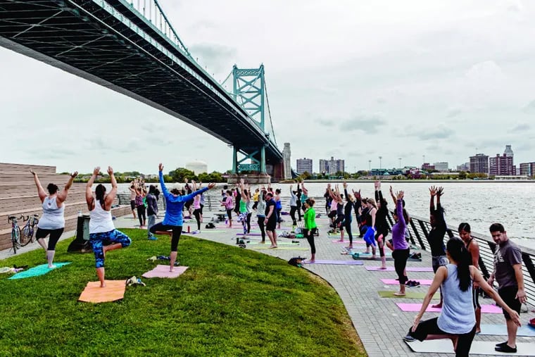 Dozens of yoga practitioners gather at the Race Street Pier in Philadelphia, Pa., on Sept. 26, 2015. The Saturday morning meeting has been seasonally active for four years.
