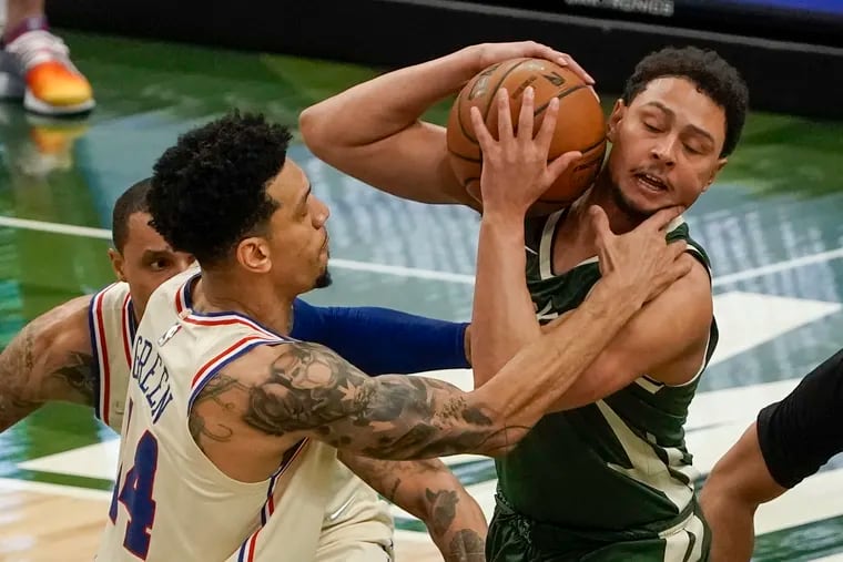 Philadelphia 76ers' Danny Green fouls Milwaukee Bucks' Bryn Forbes during the first half of an NBA basketball game Saturday, April 24, 2021, in Milwaukee.