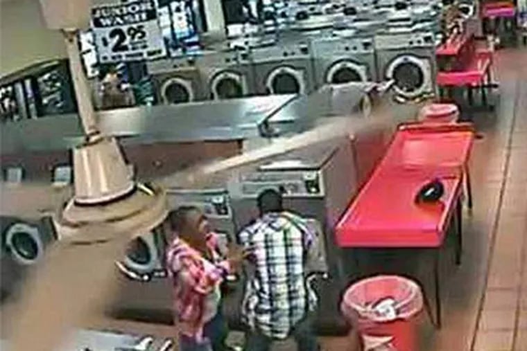 A video grab of the scary moments. The boy appeared unhurt. The video was posted by the laundromat owner's son.