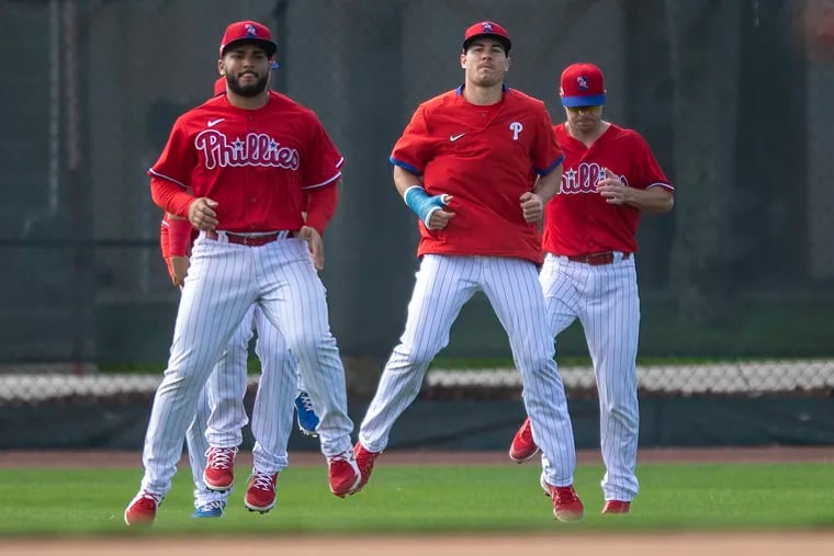 Phillies catcher J.T. Realmuto, center, broke his right thumb last month.