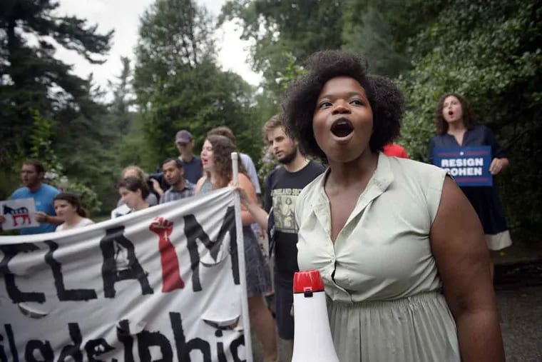 A' Brianna Morgan, of Philadelphia, and members of activist group Reclaim Philadelphia chant in front of the home of DNC host committee member David Cohen on Wednesday, July 13, 2016.