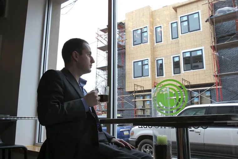 Ori Feibush is shown in his OCF Cafe at 2001 Federal St. in 2013. In the background are some of the housing units he was building in Point Breeze at the time.