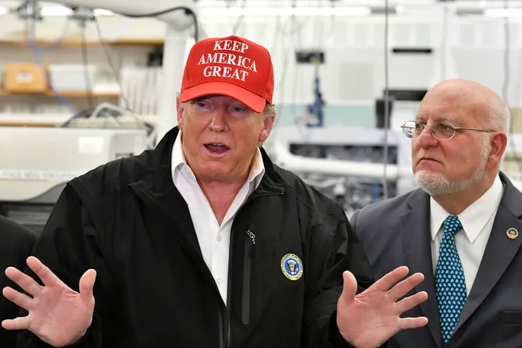 President Donald Trump alongside Robert Redfield, director of the Centers for Disease Control and Prevention, during Trump's visit to CDC headquarters in Atlanta on March 6, 2020.