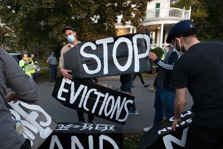 Housing activists erect a sign in front of Massachusetts Gov. Charlie Baker's house in October. A nationwide eviction ban went into effect Sept. 4 and was supposed to replace many state and local bans that had expired. But tenant advocates said there are still people unaware of the directive implemented by the Centers for Disease Control and Prevention that broadly prevents evictions for nonpayment of rent through the end of 2020. (AP Photo/Michael Dwyer, file)