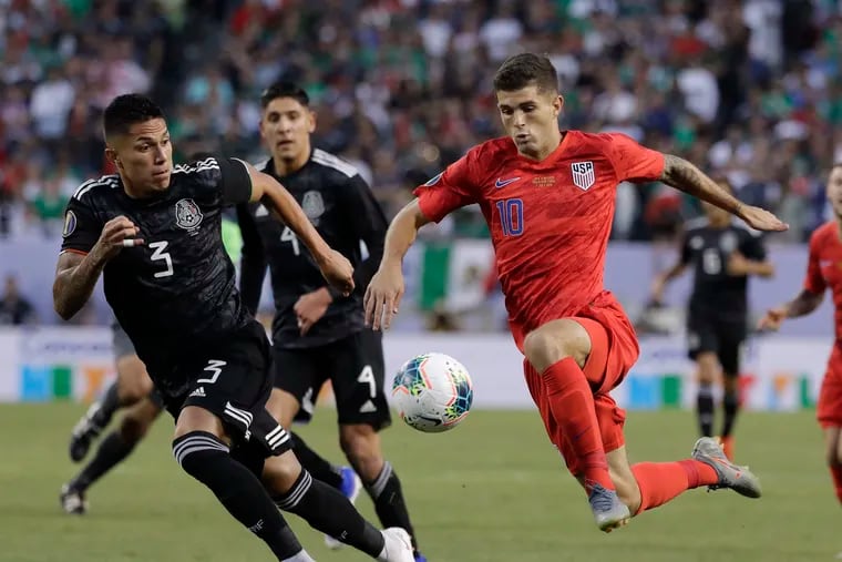 Christian Pulisic, right, playing for the United States against Mexico in the 2019 Concacaf men's Gold Cup final.
