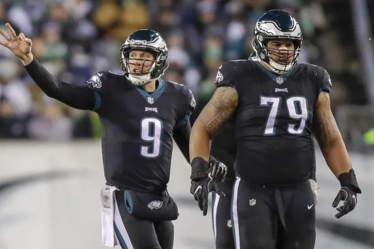 Eagles quarterback Nick Foles signals with offensive guard Brandon Brooks against the Oakland Raiders on Monday, December 25, 2017 in Philadelphia.