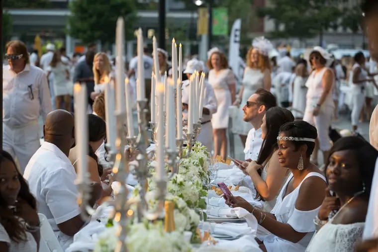 People arrive and get set up for the 7th annual Diner en Blanc at Dilworth Plaza and outside the Municipal Services Building on August 16, 2018.