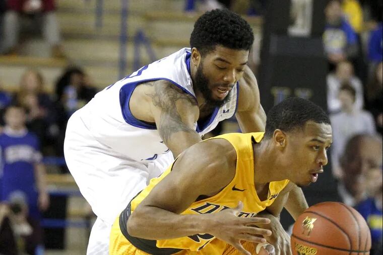 Kurk Lee (right) of Drexel beats Cazmon Hayes to a loose ball in the 2nd half on Feb. 16, 2017 at the Bob Carpenter Complex Center. CHARLES FOX / Staff Photographer
