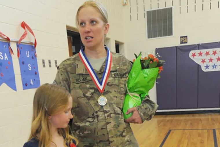 At Mary Brace School in Mount Ephraim, N.J., Army Lt. Candice Bujak has a surprise reunion with daughter Kristen Coffman, 8, after a year apart upon her return from Afghanistan on April 26, 2012. (April Saul / Staff Photographer)