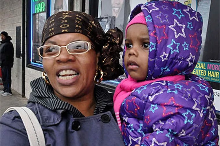 Shakiena Williams with daughter Jahira in the 44th Ward:  "I like what [Obama] talked about . . . the middle class, the economy, and schools." (Ron Traver / Staff Photographer)