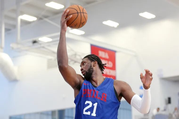 Sixers center Joel Embiid (21) grabs a rebound during the Sixers' annual Blue and White Scrimmage at the 76ers Fieldhouse in Wilmington, Del., on Saturday, Oct. 5, 2019.