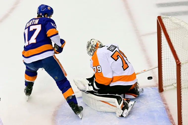 Islanders winger Matt Martin slips the puck past Flyers goaltender Carter Hart in the second period to tie Game 3, 1-1.  The Islanders went on to score two more unanswered to win, 3-1, and take a 2-1 series lead. (Frank Gunn / The Canadian Press via AP)