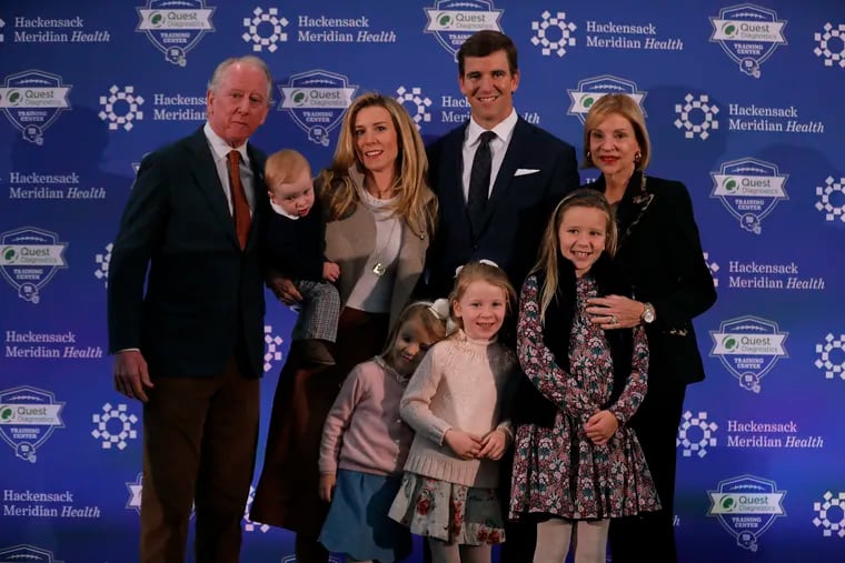Eli Manning poses with his family and parents after announcing his retirement on Friday.