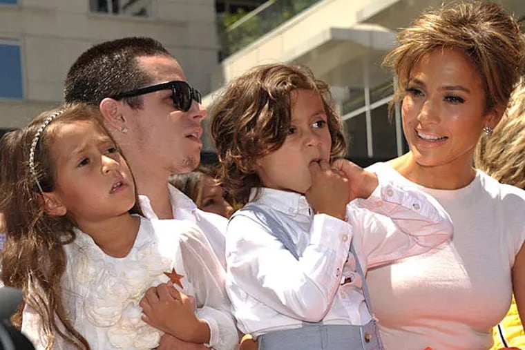 Jennifer Lopez (right) with Beau &quot;Casper&quot; Smart, holding her two children, Emme Muniz (left) and Maximilian Muniz. (JOHN SHEARER / AP)