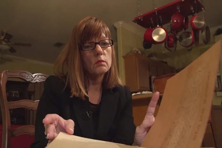 Debbie Wesson Gibson looks through a scrapbook from her senior year in high school, where several pages include what she says is evidence of her relationship with Roy Moore when she was 17 and he was 34.