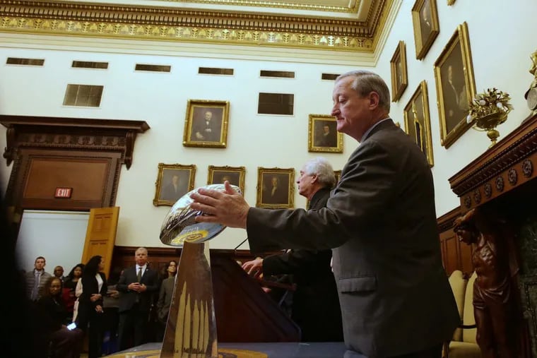 Philadelphia Mayor Jim Kenney touches the Lombardi trophy at a City Hall press conference where officials revealed the their plan for the upcoming Super Bowl Parade in Philadelphia on Thursday, February 8, 2018.