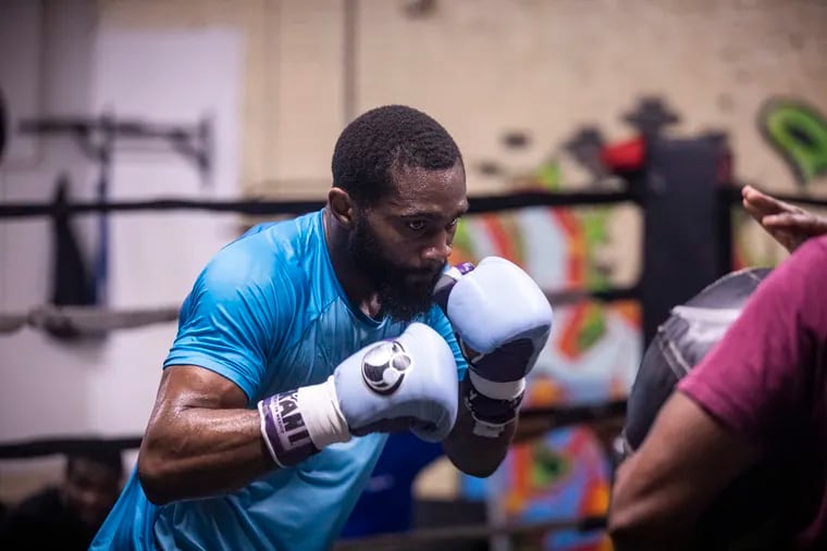 Bozy Ennis, boxing coach and father, training his son Jaron Ennis, 24, at his gym in Philadelphia.