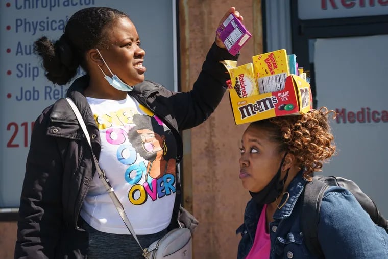 Nay Jackson selects candy from Lynette Morrison, the Candy Lady, in West Philadelphia, Wednesday, March 16, 2022.