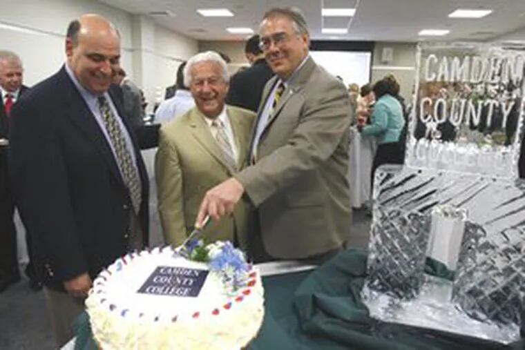 Camden County College President Raymond Yannuzzi, (right) cuts a cake to celebrate the conference center&#0039;s opening. With him are (left) trustee chair Kevin G. Halpern and treasurer Louis F. Cappelli Sr.