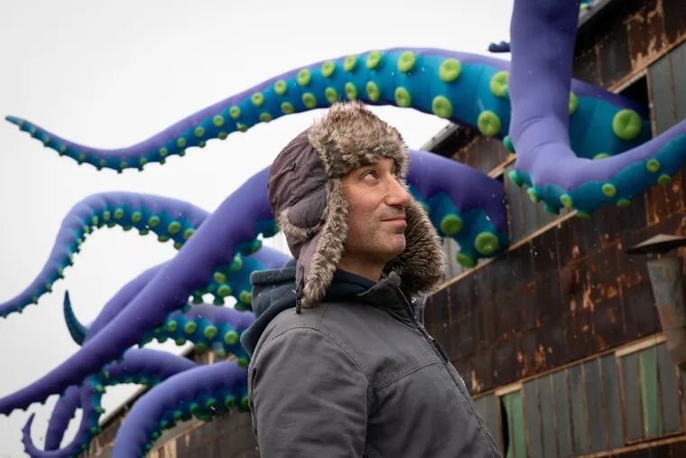 Artist Filthy Luker with the inflatable sea monster at the Navy Yard