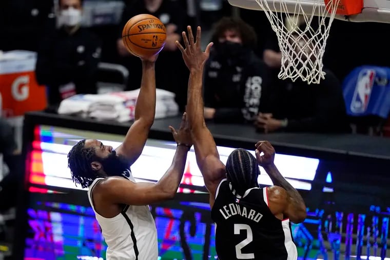 Brooklyn Nets guard James Harden shooting as Los Angeles Clippers forward Kawhi Leonard defends on Sunday.