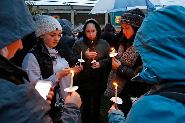 A group of girls wait for the start of a vigil at the intersection of Murray and Forbes Avenues in the Squirrel Hill section of Pittsburgh, not far from where 11 people were shot to death at Tree of Life synagogue.