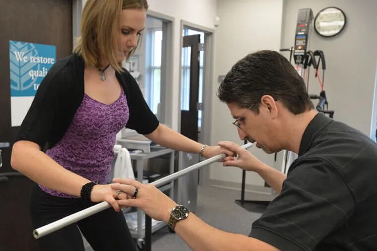 Dr. David Aiken works with Haley Pillars on her physical therapy in Charlotte, North Carolina, on April 15, 2013. (Davie Hinshaw/Charlotte Observer/MCT)