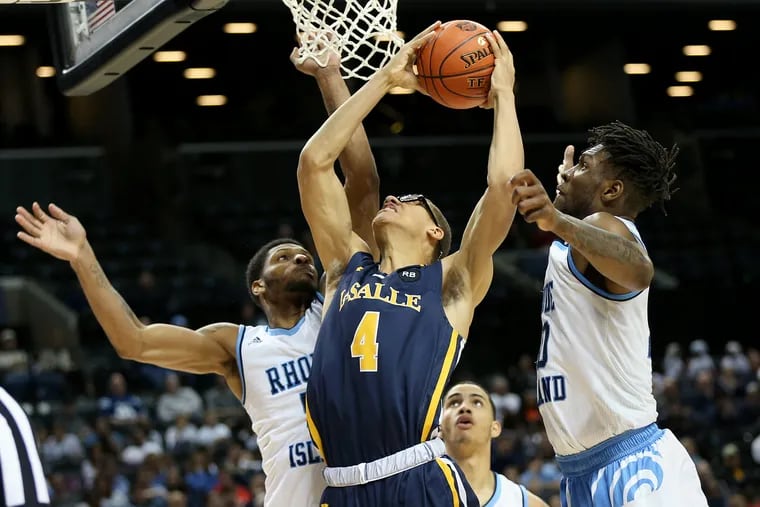 La Salle's Miles Brookins (4) attempts a shot between Rhode Island's Ryan Preston (5) and Cyril Langevine (10) during their second-round Atlantic 10 Tournament game at the Barclays Center in Brooklyn, N.Y., on Thursday, March 14, 2019.