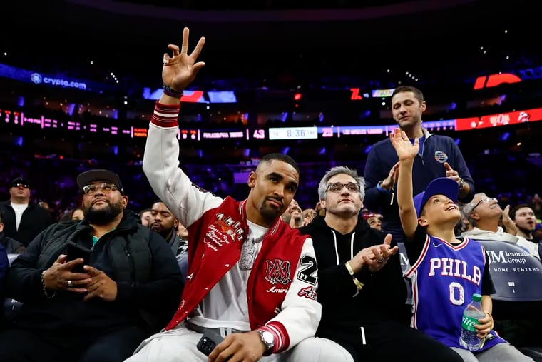 Eagles quarterback Jalen Hurts acknowledges fans attending the Sixers game against the Los Angeles Lakers on Monday, November 27, 2023 in Philadelphia.