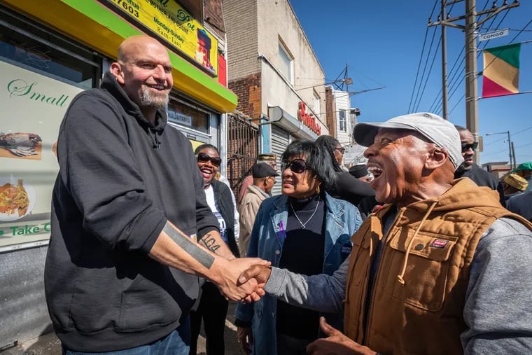 John Fetterman, left, talks with former Councilmember Jannie Blackwell, center, and Ronald Waters, right, Third Ward leader, outside the restaurant African Small Pot.