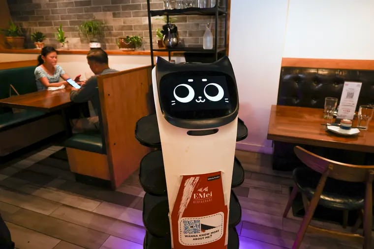 This robot cat server, known as a BellaBot, assists waitstaff at EMei in Chinatown.