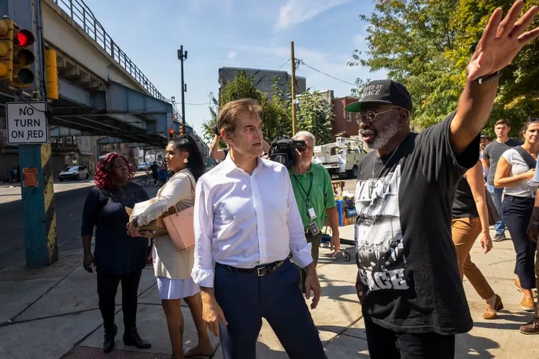 Mehmet Oz speaking with Pastor Ron Dawkins (right) with Saved by Grace Worship Center beside McPherson Square Park on Sept. 19.