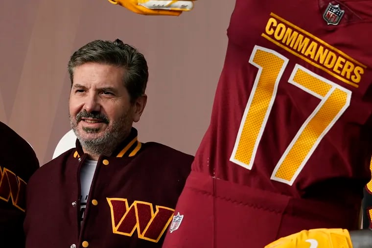 Washington Commanders' Dan Snyder poses for photos during an event to unveil the NFL football team's new identity in February in Landover, Md.