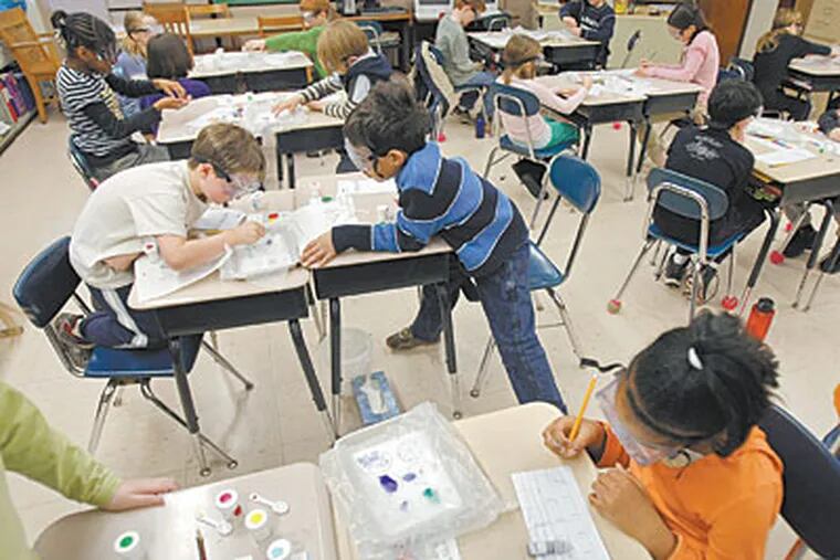 At Fern Hill Elementary School in West Chester, third graders perform a scientific experiment in which they use their senses to describe substances. Science education is beginning earlier in many schools. (MICHAEL S. WIRTZ / Staff Photographer)