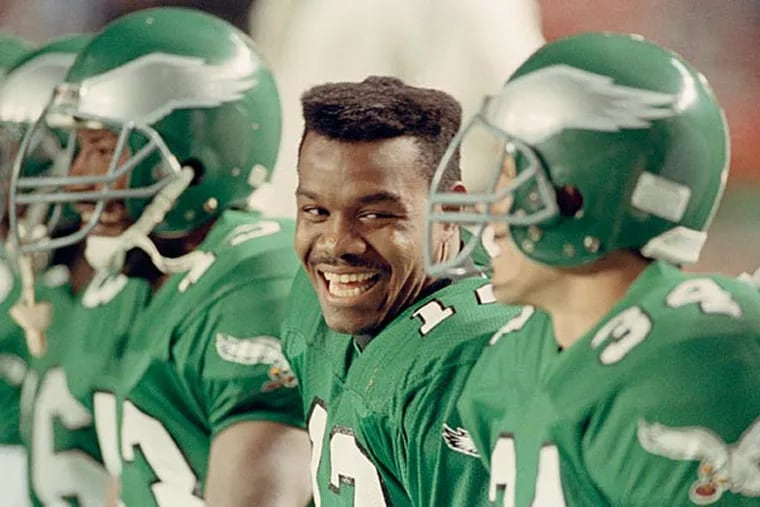 Eagles quarterback Randall Cunningham laughs with teammates on the bench in the closing minutes of the Eagles 28-14 win over the Washington Redskins at Philadelphia's Veterans Stadium, Nov. 13, 1990. Cunningham threw for 132 yards and one touchdown as well as rushing for 42 yards on 5 carries. (Rusty Kennedy/AP)