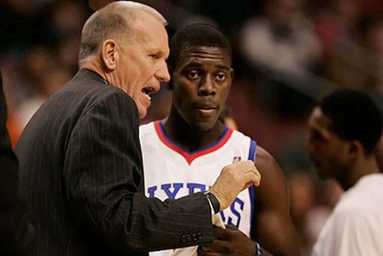 Doug Collins instructs second-year point guard Jrue Holiday during the Sixers game against the Pacers. (Michael Bryant / Staff Photographer)