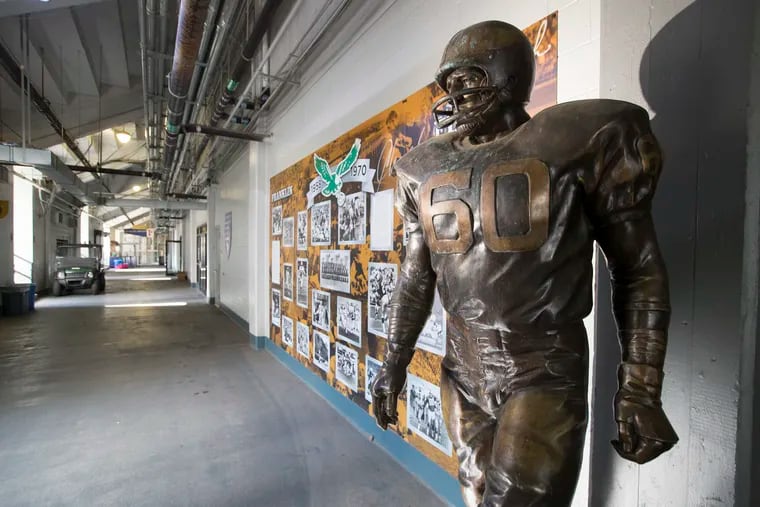 The Chuck Bednarik statue and Eagles mural underneath the north stands at Franklin Field.