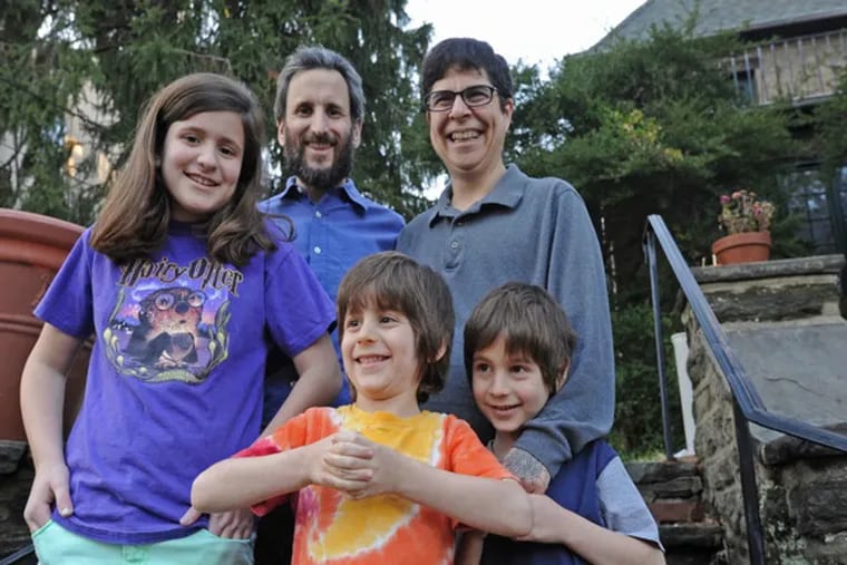 At their Philadelphia home, Yoel Solis, who was once a woman and is now a man, right; husband Matthew Solis, left; daughter Erica Solis; and twin 5-year old brothers, Colin, center; and Phillip Solis on Dec. 21, 2013 .  ( APRIL SAUL  / Staff )