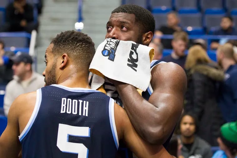 Phil Booth embraces fellow senior Eric Paschall in the final moments of Villanova's loss to Purdue on Saturday.