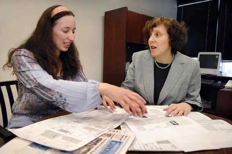 Graphics editor Julia Elkin (left) goes over page layouts with Lisa Hostein, executive editor of the Jewish Exponent. &quot;Everybody should feel engaged in the Jewish community, and a newspaper is a great way to make that happen,&quot; Hostein said.