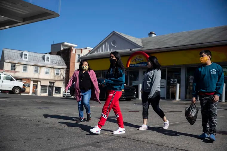 Carmela Apolonio Hernandez and children Yoselin, 14, Keyri, 16, and Edwin, 12, leave a gas station after buying snacks in Philadelphia on Monday. Hernandez and her four children have spent more than three years in church sanctuary, but now will be able to live freely while pursuing a visa that would allow them to live and work permanently in the United States.