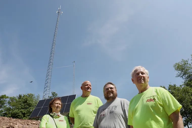 From left, Rural Broadband Cooperative board members Deborah Grove and Tom Bracken, president Brandon Beck, and Ken Diven, one of the founding members, at the cooperative's wireless internet tower in Mill Creek, Pa. Local residents worked together to build and maintain the tower, which became operational in October 2019, because they were frustrated with slow internet service.